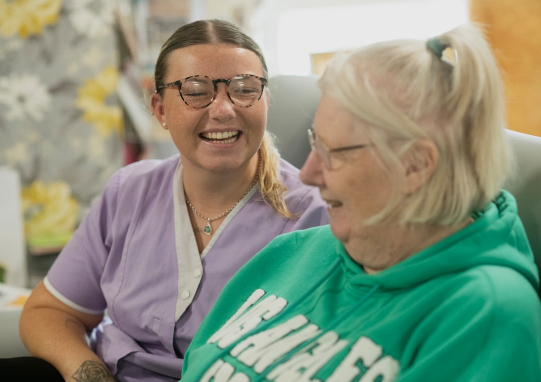 A support worker and participant sharing a warm moment at home