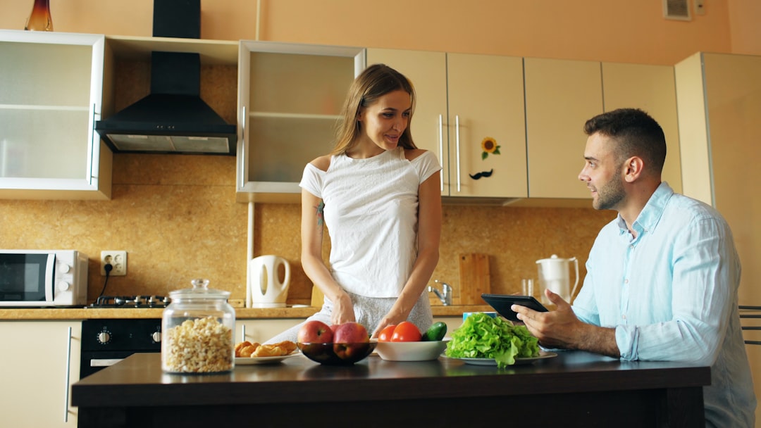 Two people preparing breakfast together in a bright morning kitchen